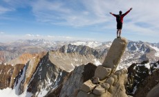 Man standing on edge of cliff