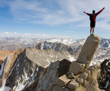 Man standing on edge of cliff