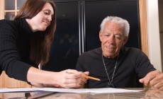 Financial adviser helping elderly man with retirement benefits