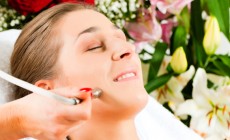 Woman in cosmetic salon receiving facial