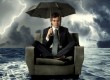 Man stranded at sea with umbrella