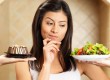 Woman choosing between salad and cake