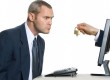 Man being handed a padlock through his laptop