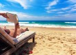 Woman reading book at beach