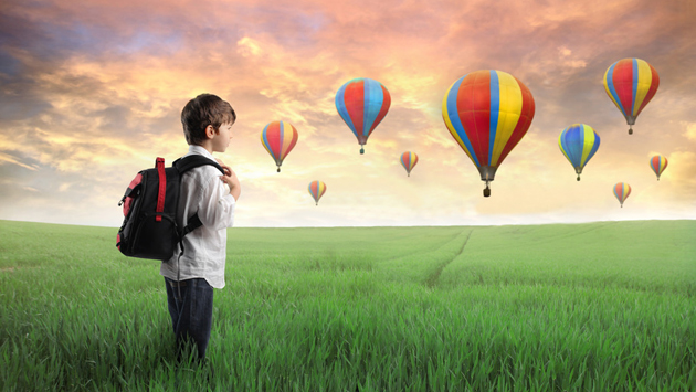 boy-standing-in-field-with-hot-air-balloons.jpg