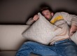 Frightened man watching a horror movie
