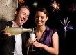 Man pouring champagne into woman's glass at party