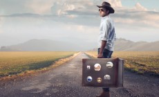 Young guy of countryside holding a suitcase