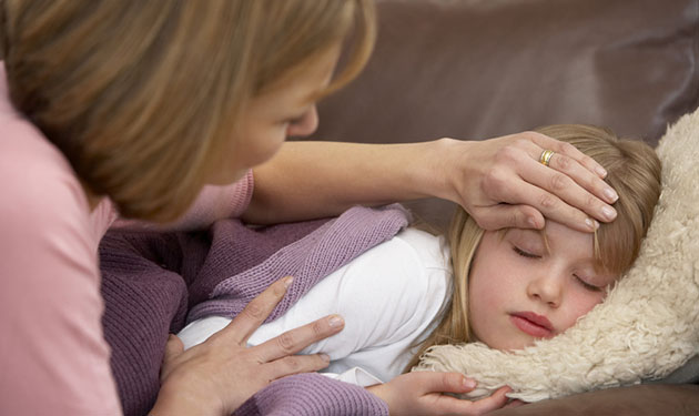 Mother Taking Temperature Of Sick Daughter