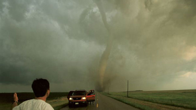 Storm chasers in front of tornado