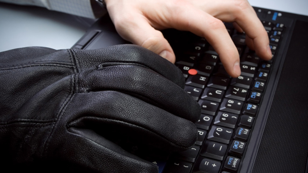 Hacker hands on laptop keyboard
