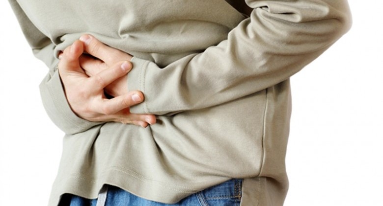 boy holding hands on his stomach over white background, pain