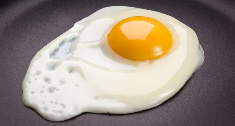 Fresh white fried egg on frying pan