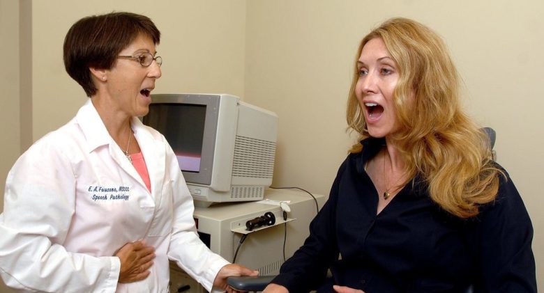 Speech Pathology Beth Anne Fausone listens as Molly Klimas holds her diaphragm and performs vocal exercises at the Comprehensive Ear, Nose and Throat center. Earlier this year, Klimas suffered a viral infection that paralyzed her right vocal cord, reducing her voice to a whisper. (Paul L. Newby, II | The Grand Rapids Press)