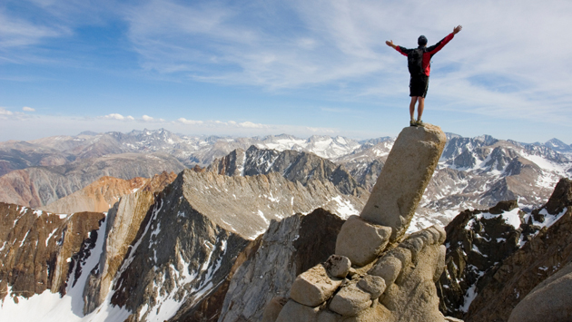 Man standing on edge of cliff