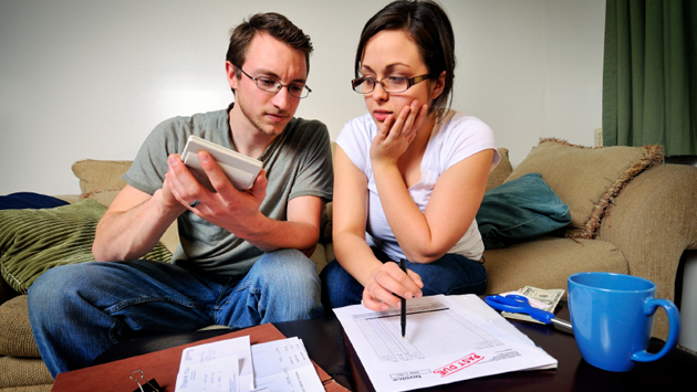 Young couple calculating budget