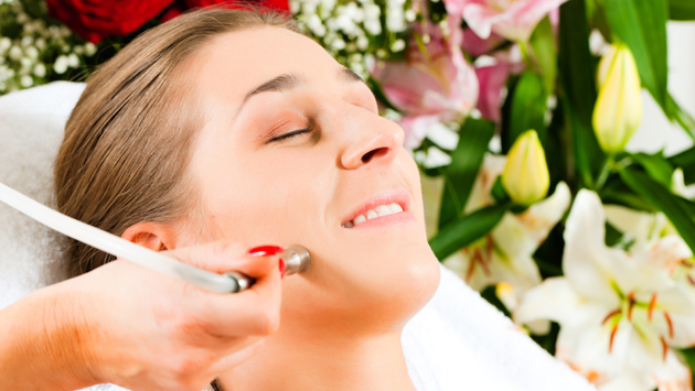 Woman in cosmetic salon receiving facial