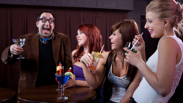 Man making women laugh at nightclub