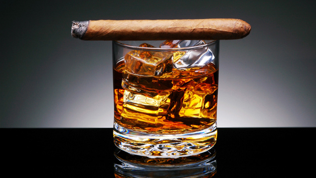 Cigar on top of alcoholic drink