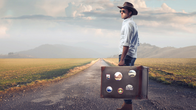 Young guy of countryside holding a suitcase